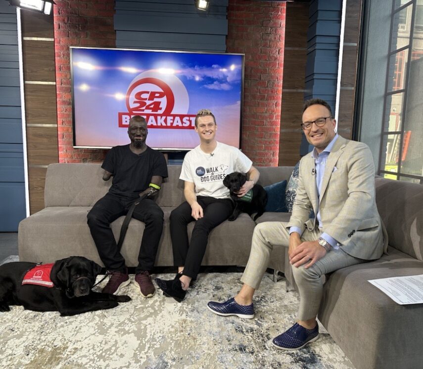 Dog Guide client with Service dog smile at CP24 studio with TV host and staff member